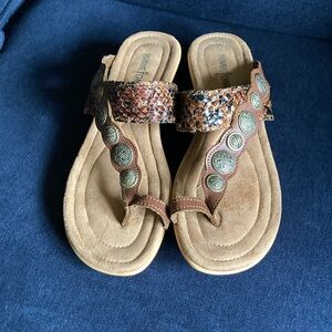 Minnetonka S.W. inspired flip flop wedge in snakeskin leather &ornate medallions